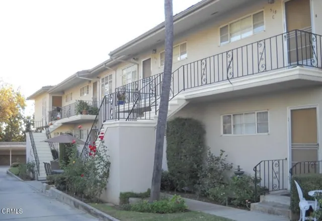 a front view of a house with plants