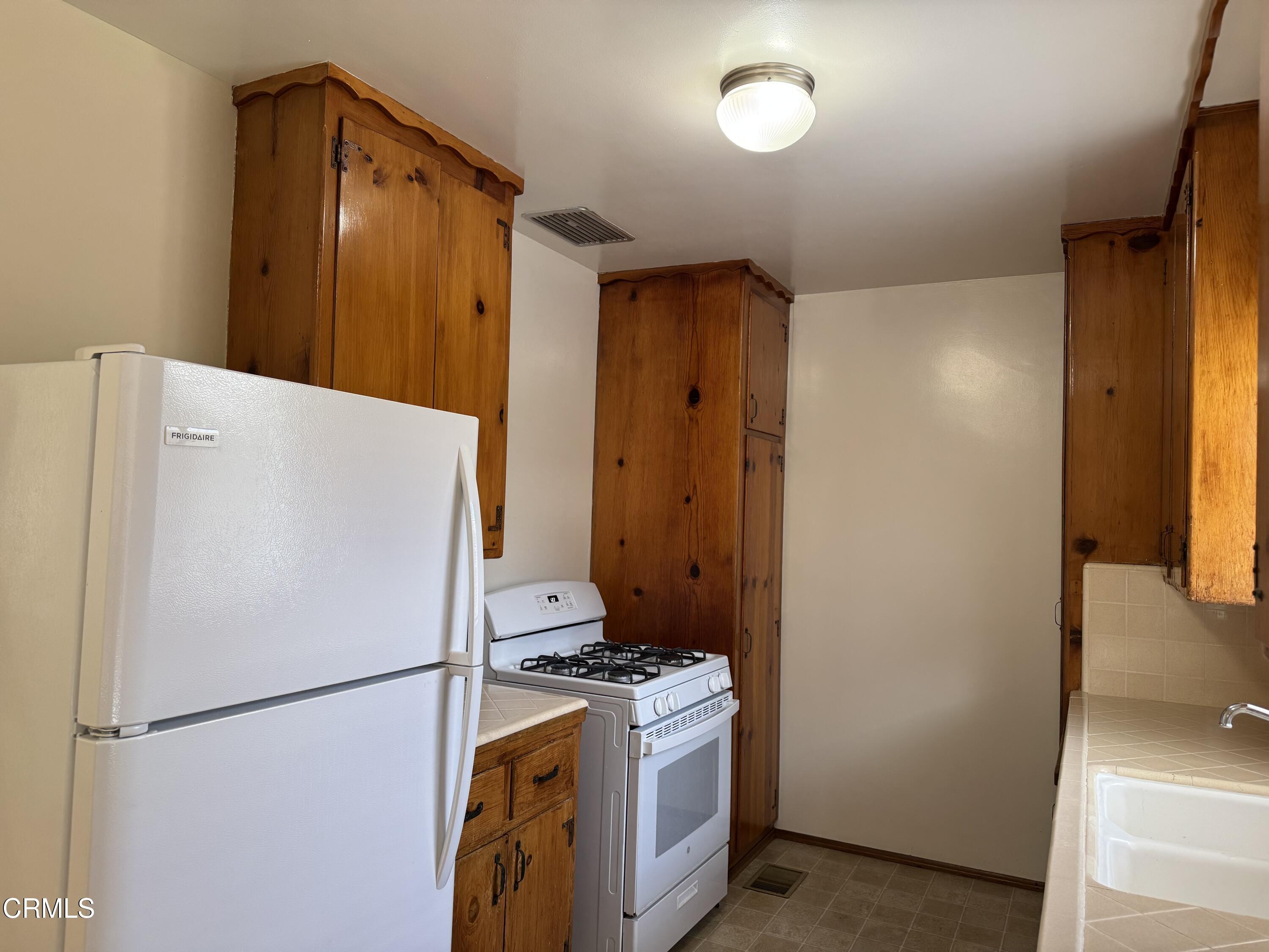 516 Linwood Avenue, Unit A Monrovia, CA 91016 - Photo 4 of 12 a white refrigerator freezer and a stove sitting inside of a kitchen