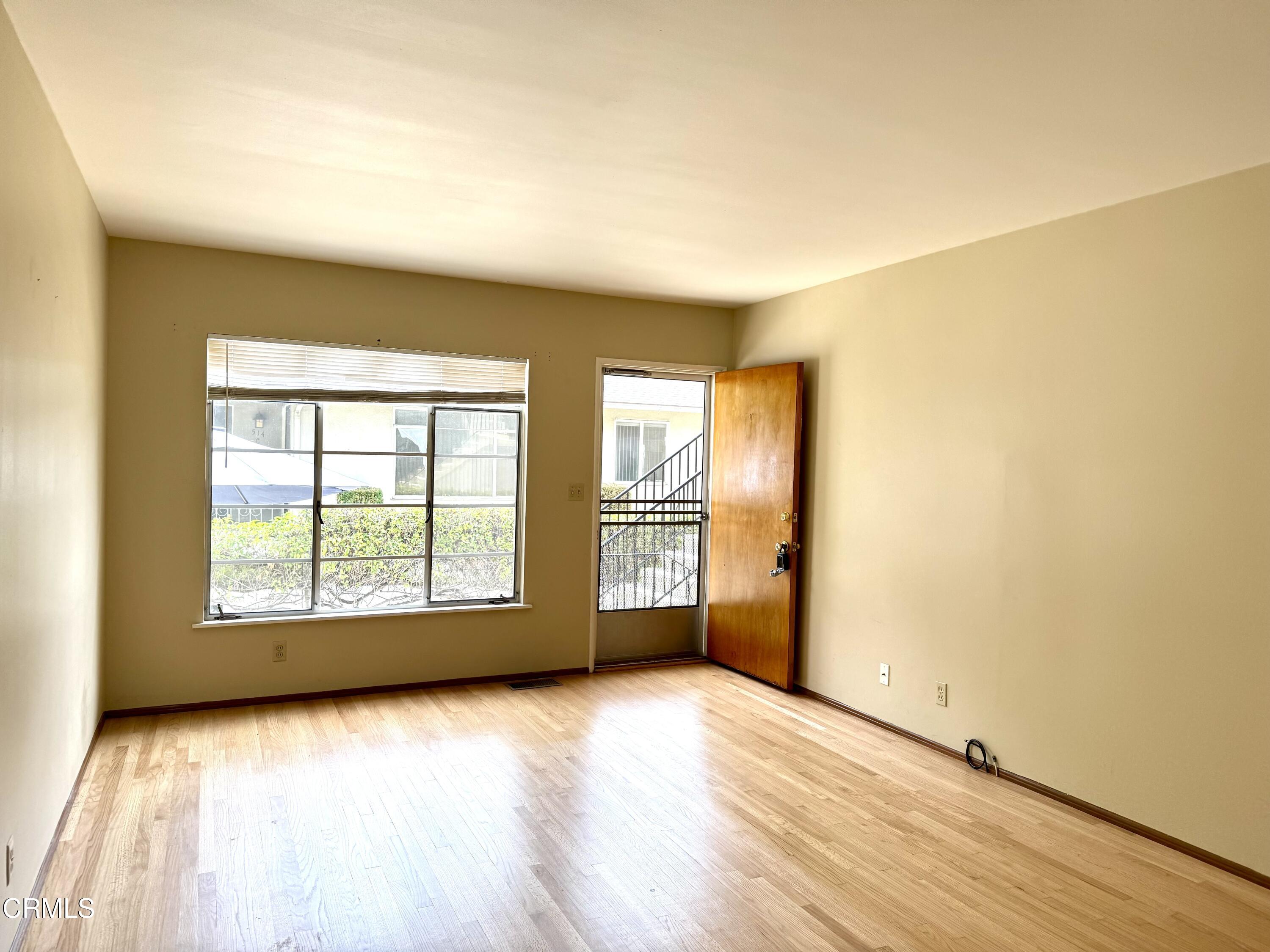 516 Linwood Avenue, Unit A Monrovia, CA 91016 - Photo 6 of 12 an empty room with wooden floor and windows