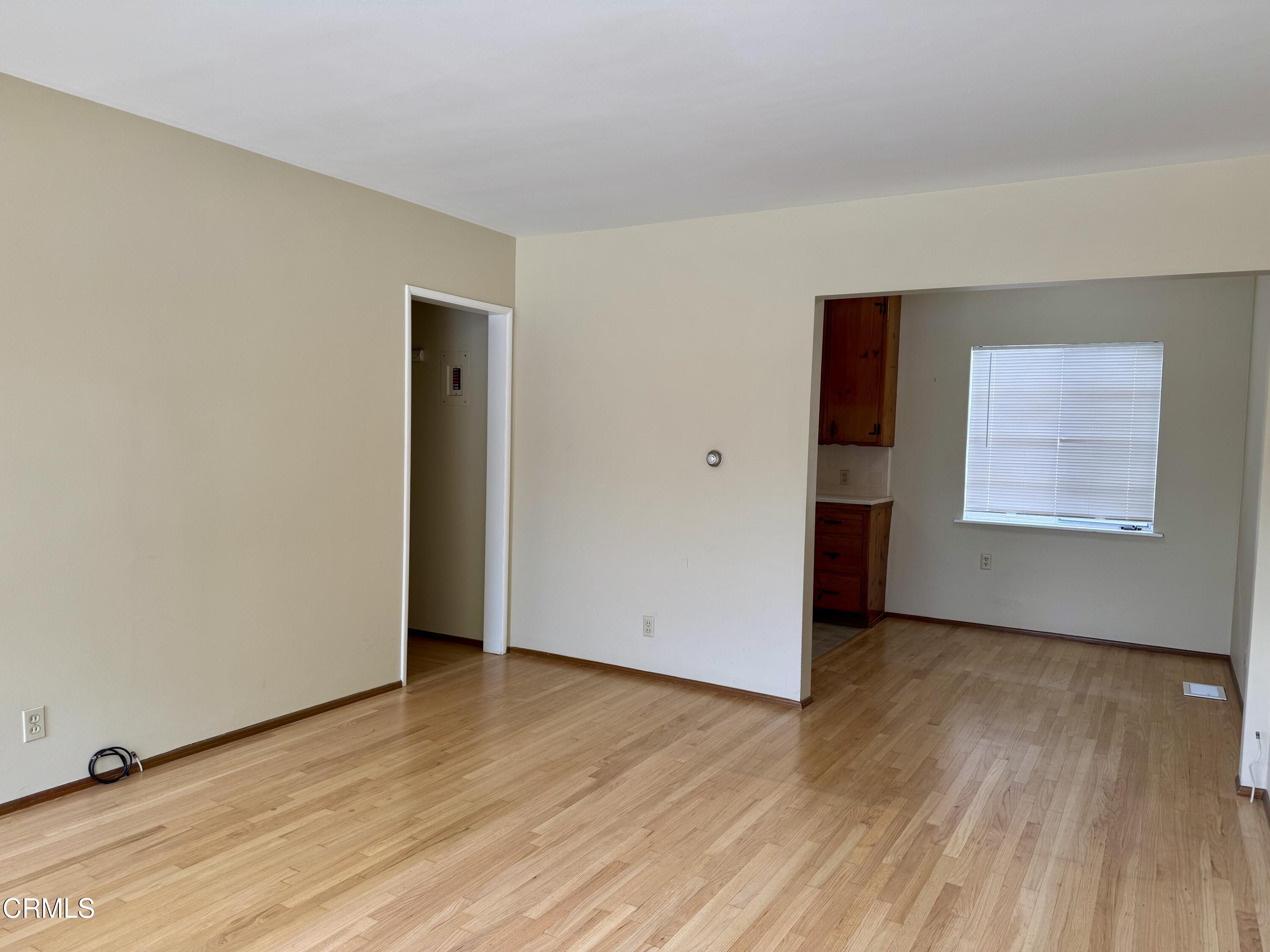 516 Linwood Avenue, Unit A Monrovia, CA 91016 - Photo 7 of 12 an empty room with wooden floor and windows