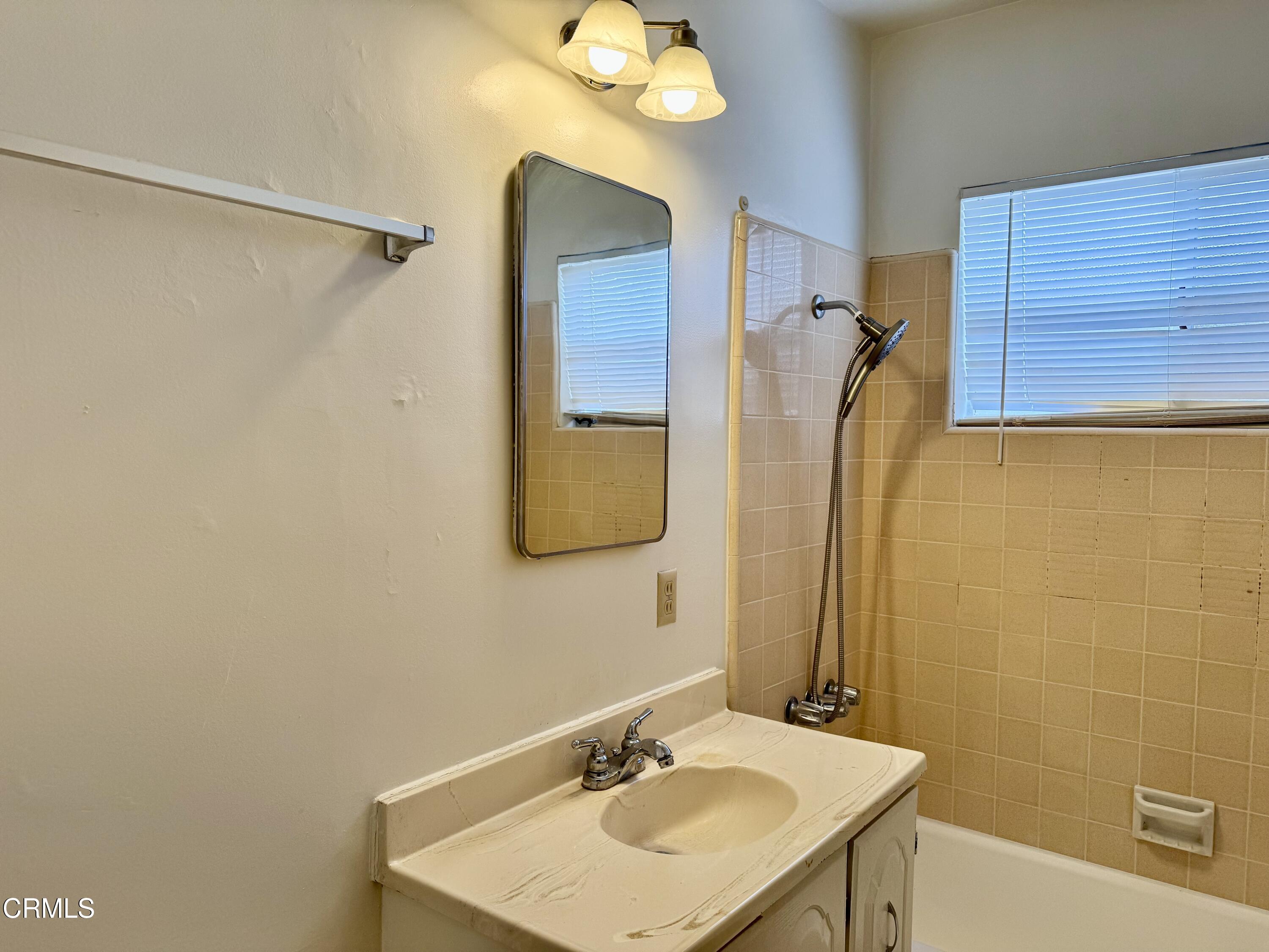 516 Linwood Avenue, Unit A Monrovia, CA 91016 - Photo 8 of 12 a bathroom with a sink and a mirror