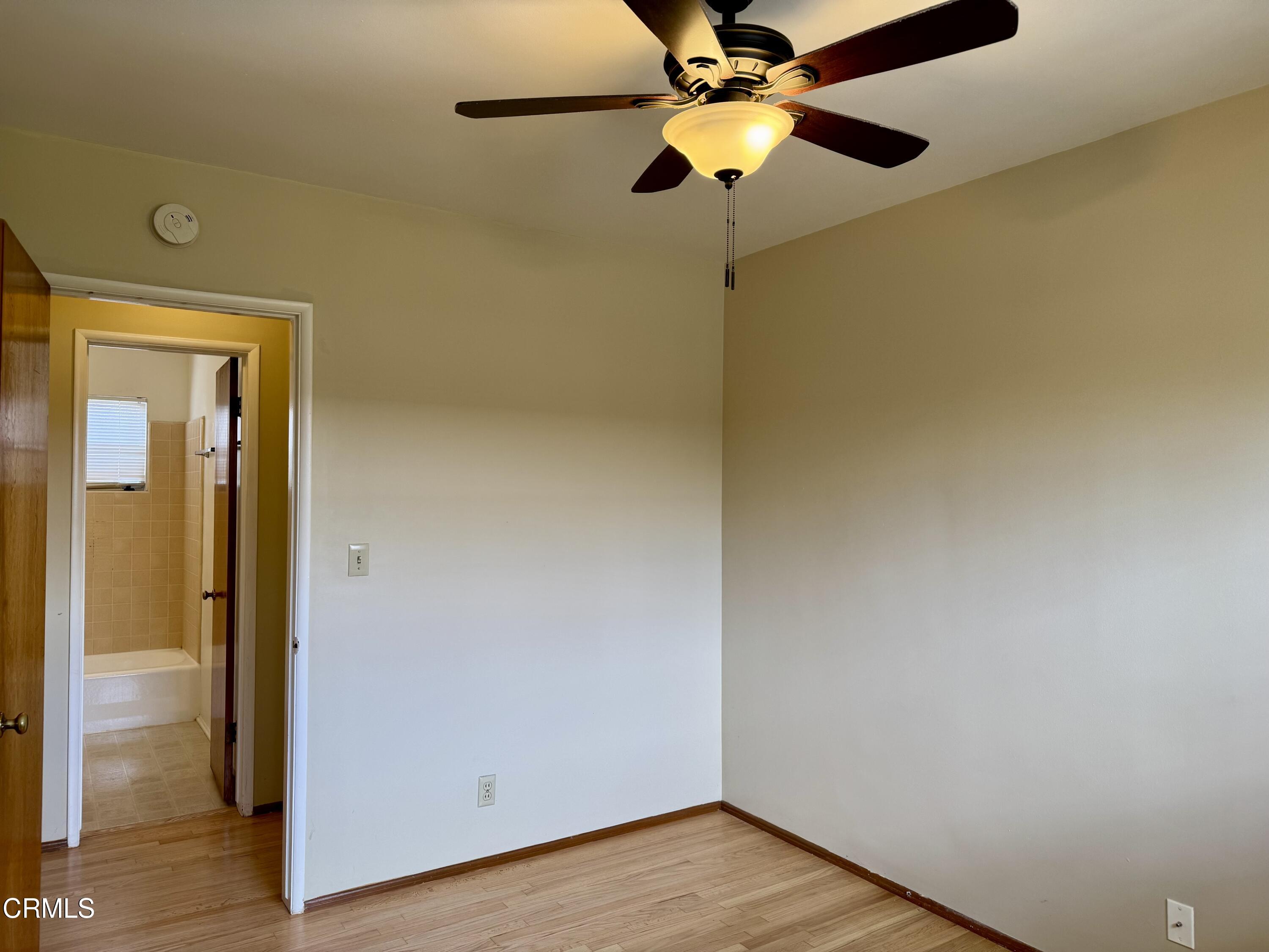 516 Linwood Avenue, Unit A Monrovia, CA 91016 - Photo 10 of 12 a view of a room with wooden floor a ceiling fan and a bathroom