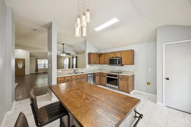a kitchen with a stove a refrigerator and a sink