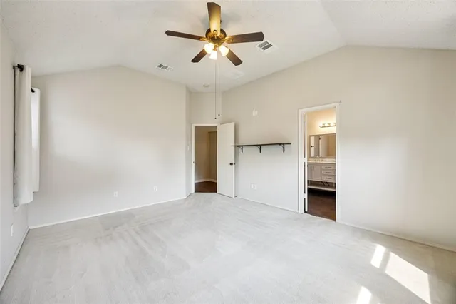 a view of a kitchen with a refrigerator and a ceiling fan