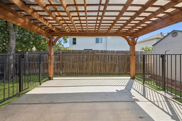a view of backyard with wooden fence