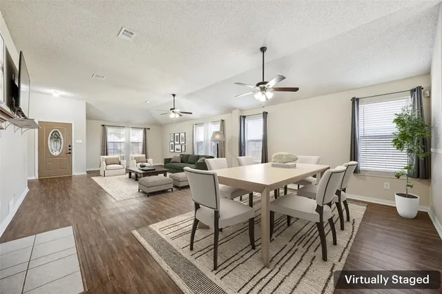 a view of a dining room with furniture and wooden floor