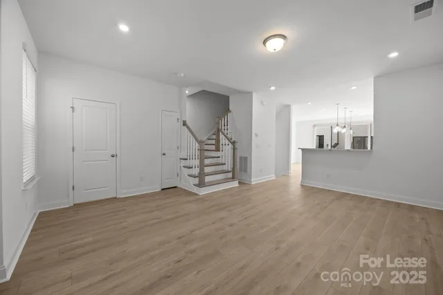 a view of an empty room with a kitchen