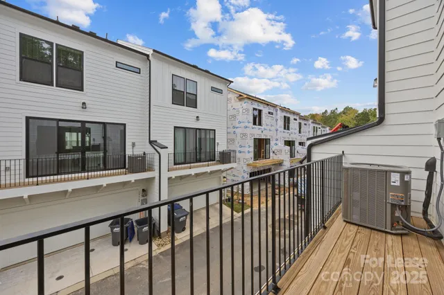 a view of a balcony with wooden floor and fence