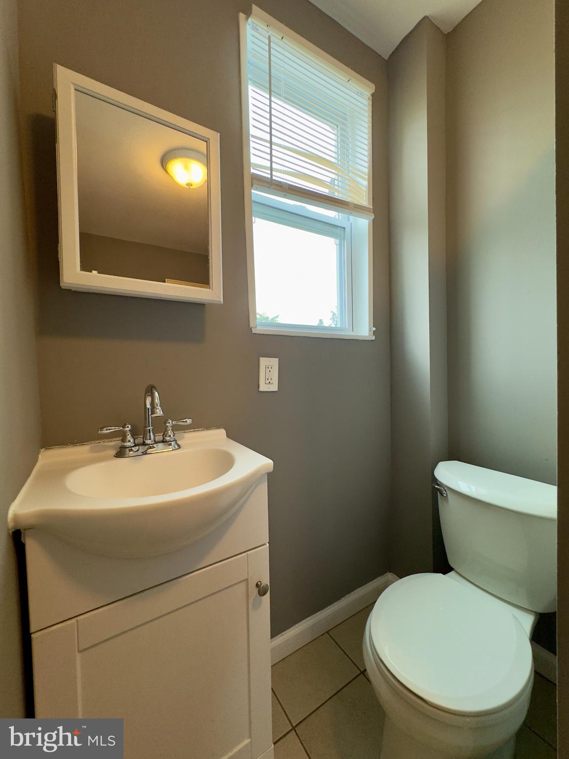1931 Griffis Avenue Baltimore, MD 21230 - Photo 11 of 17 a white toilet sitting next to a bathroom sink