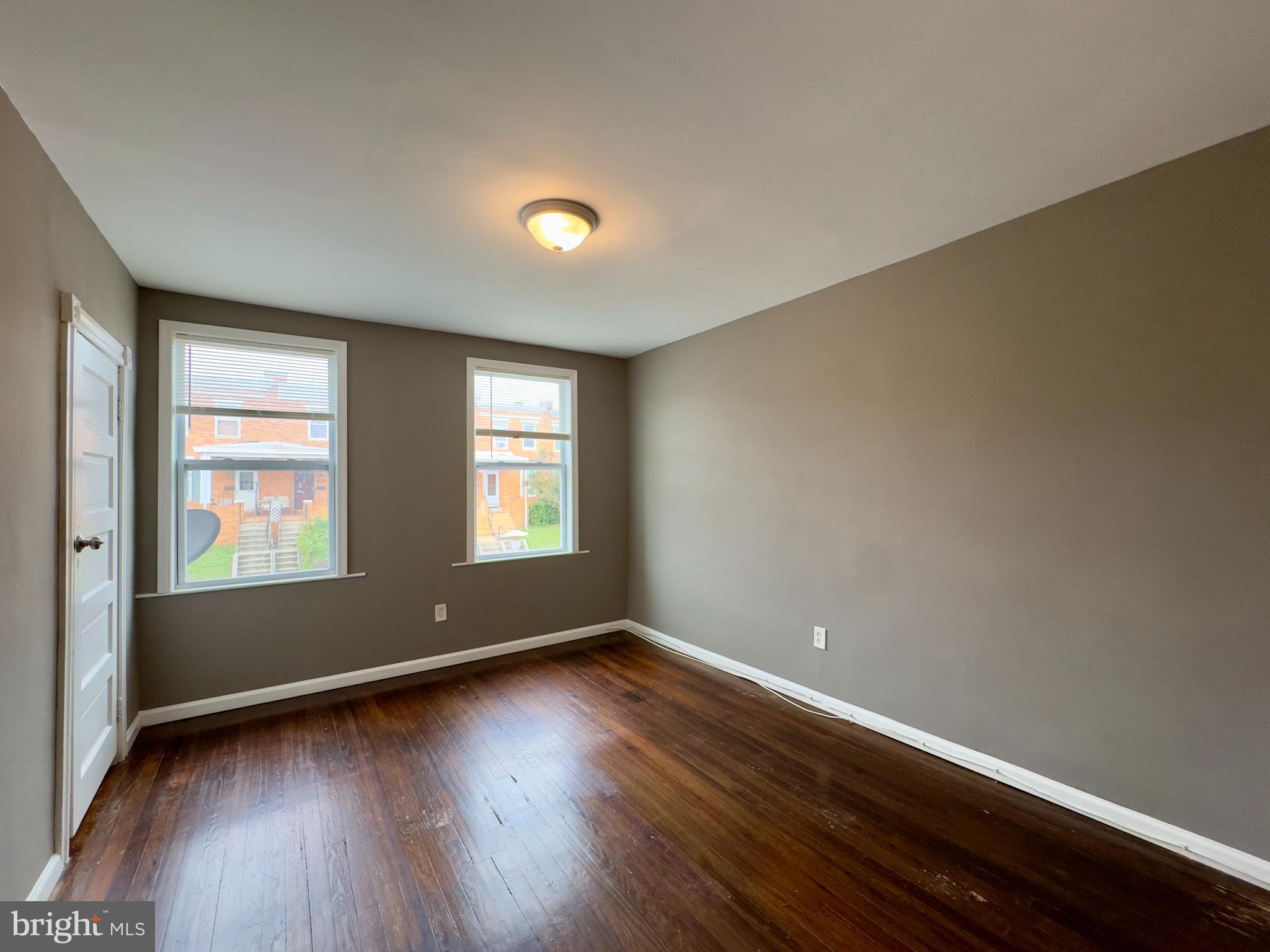 1931 Griffis Avenue Baltimore, MD 21230 - Photo 13 of 17 an empty room with wooden floor and windows