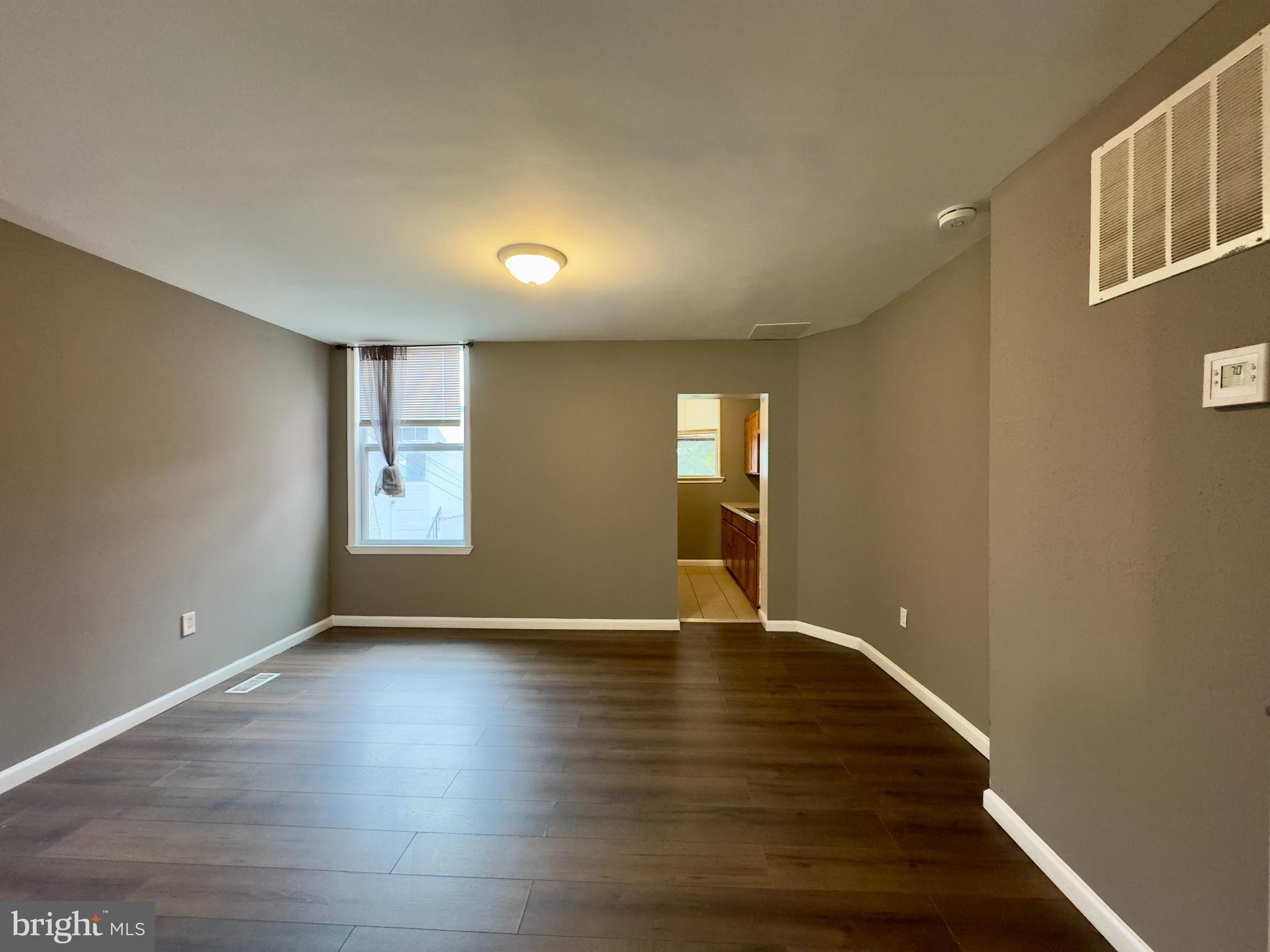 1931 Griffis Avenue Baltimore, MD 21230 - Photo 3 of 17 a view of an empty room with glass door and wooden floor