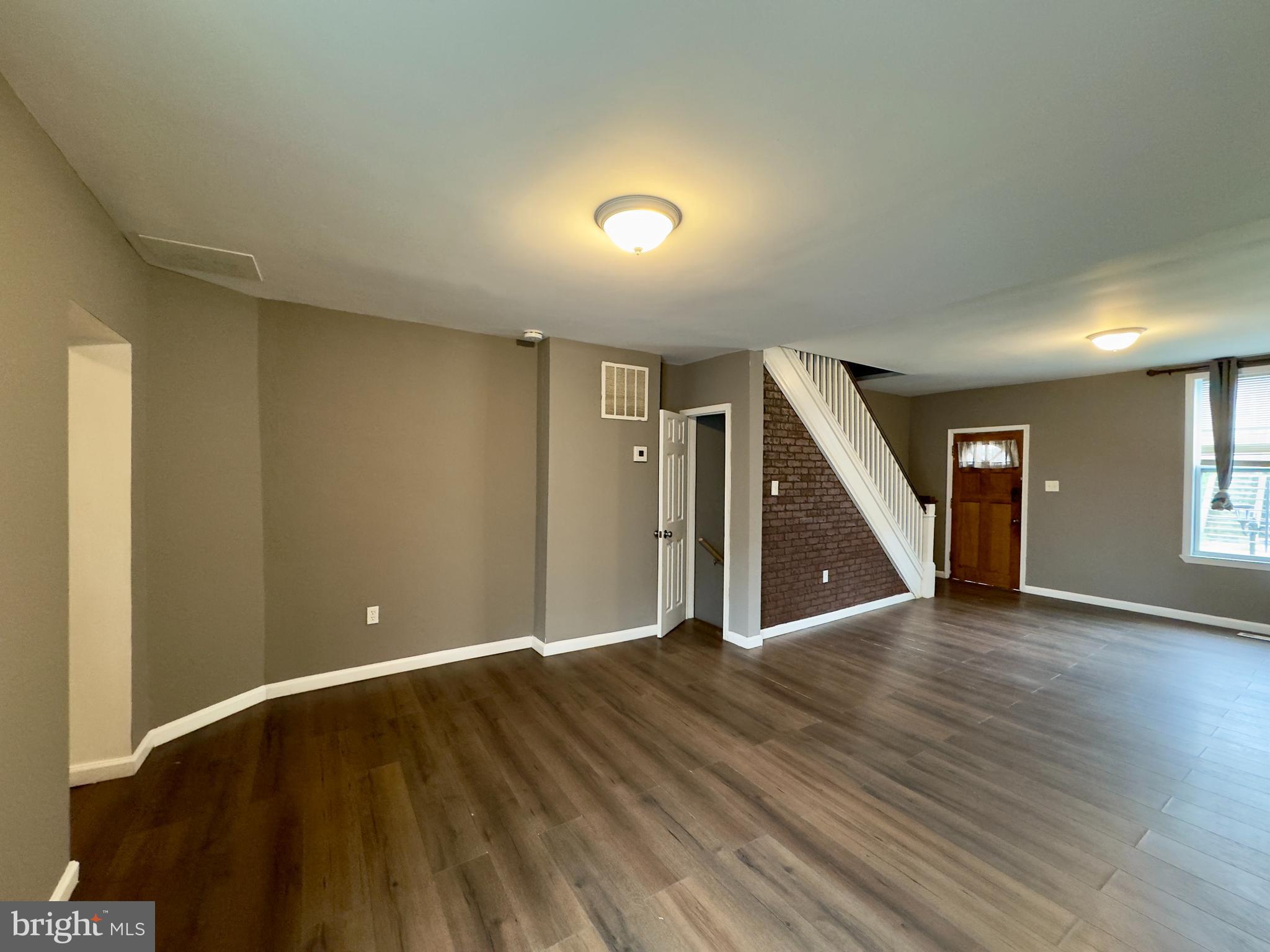 1931 Griffis Avenue Baltimore, MD 21230 - Photo 4 of 17 a view of an empty room with wooden floor