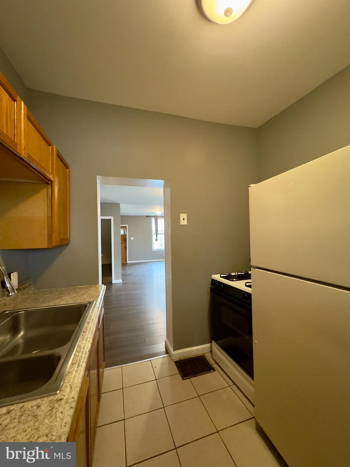 1931 Griffis Avenue Baltimore, MD 21230 - Photo 6 of 17 a kitchen with a sink and a refrigerator