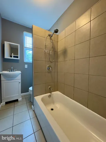 a white toilet sitting next to a bathroom sink