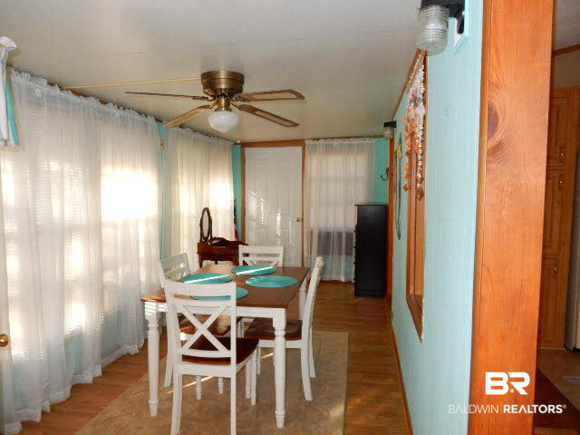 548 Escambia Loop Lillian, AL 36549 - Photo 6 of 16 Sunroom with laminate floors