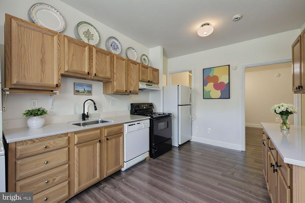 615 South Paca Street Baltimore, MD 21230 - Photo 11 of 34 a kitchen with stainless steel appliances granite countertop a sink a stove a refrigerator and cabinets