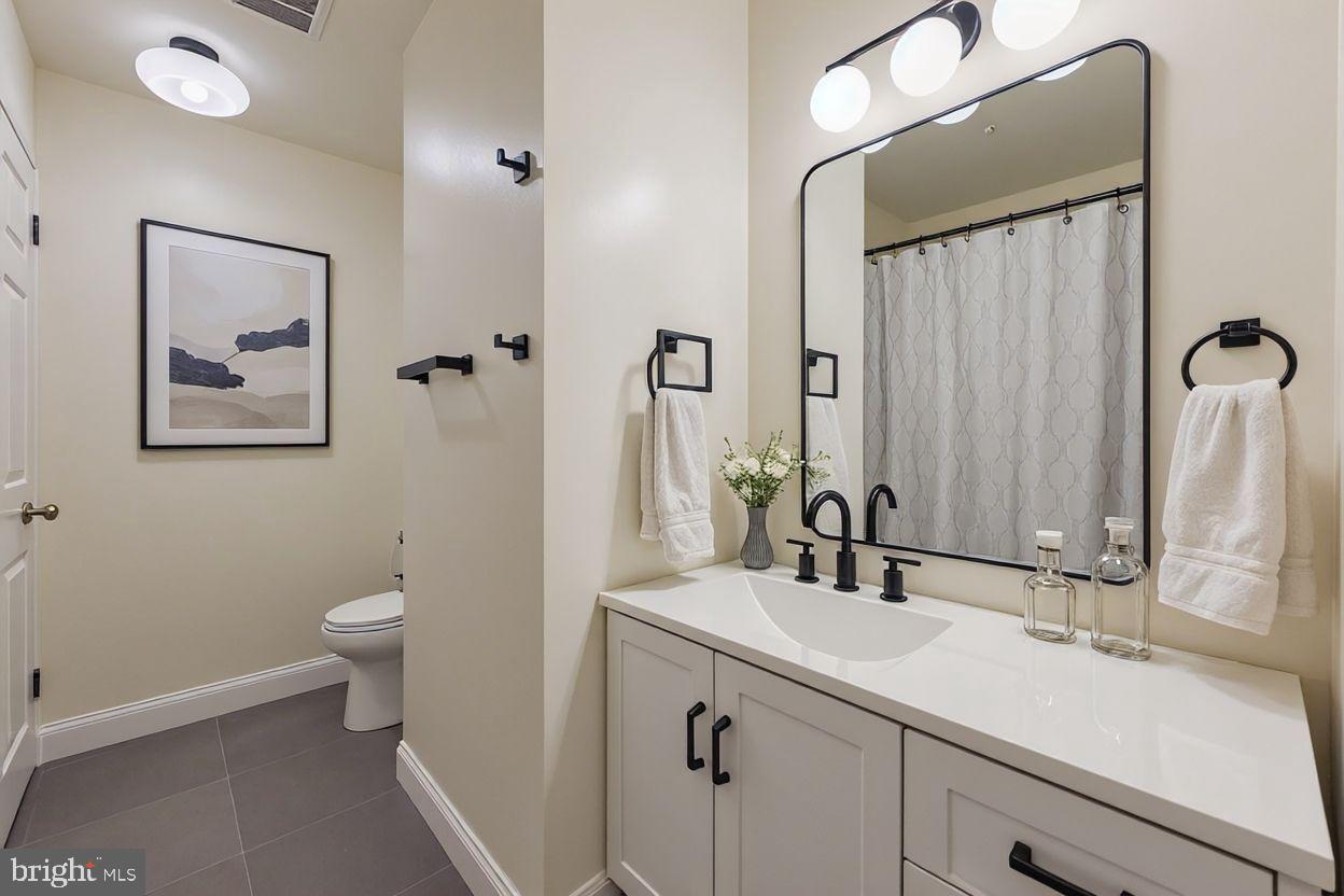 615 South Paca Street Baltimore, MD 21230 - Photo 15 of 34 a bathroom with a sink and a mirror
