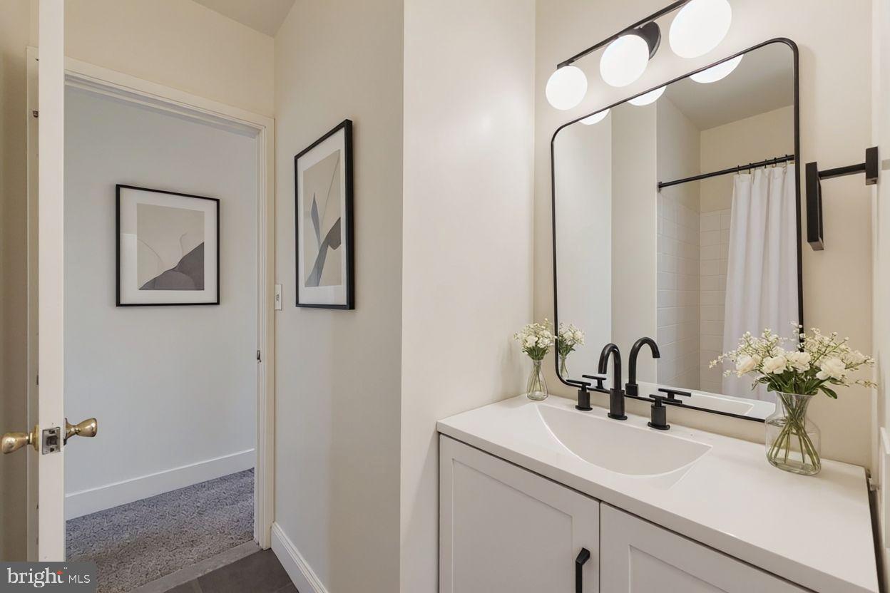 615 South Paca Street Baltimore, MD 21230 - Photo 18 of 34 a bathroom with a sink and a mirror
