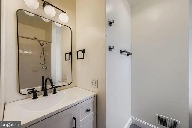 a bathroom with a sink and mirror