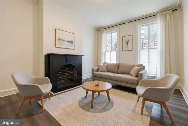 a living room with furniture and a fireplace