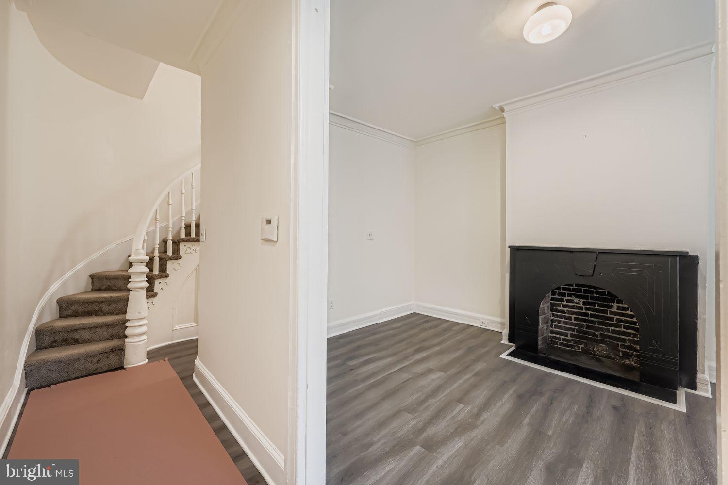 615 South Paca Street Baltimore, MD 21230 - Photo 5 of 34 a view of an empty room with wooden floor and stairs