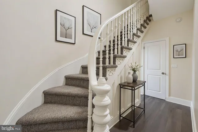 a living room with furniture and a stairs