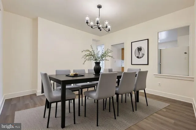 a view of a dining room with furniture and chandelier