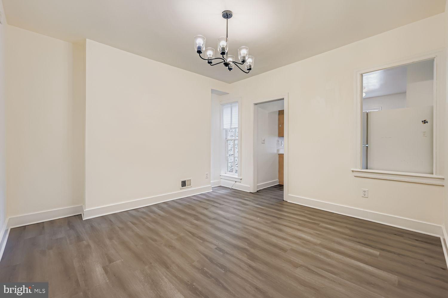 615 South Paca Street Baltimore, MD 21230 - Photo 9 of 34 a view of an empty room with wooden floor and a window