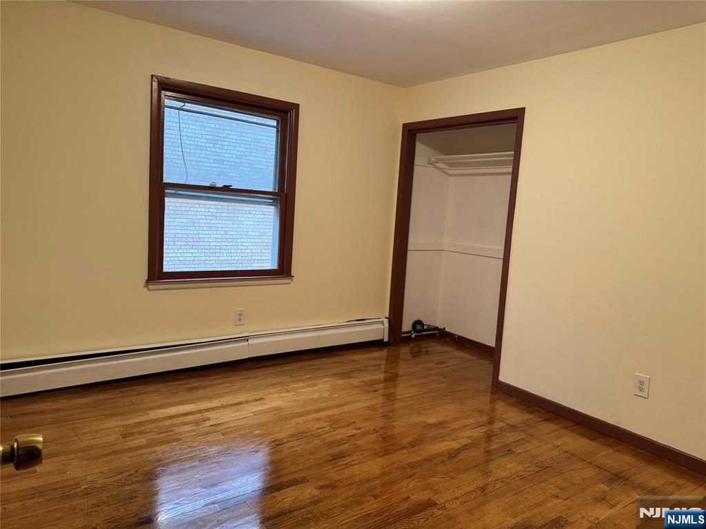 4 Chestnut Street Rutherford, NJ 07070 - Photo 15 of 29 an empty room with wooden floor and windows