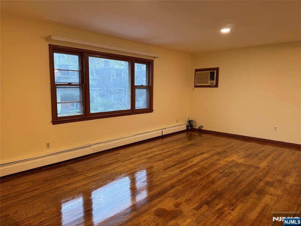 4 Chestnut Street Rutherford, NJ 07070 - Photo 8 of 29 a view of an empty room with wooden floor and a window