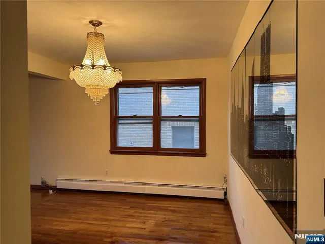 a view of a livingroom with wooden floor and staircase