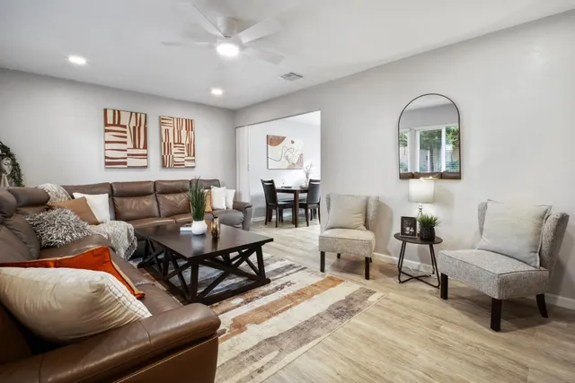 a living room with furniture and wooden floor