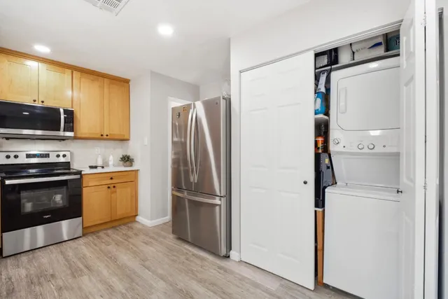 a kitchen with stainless steel appliances a refrigerator and a stove top oven