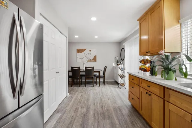 a kitchen with stainless steel appliances granite countertop a refrigerator and a sink