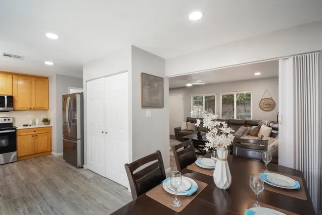 a living room with furniture kitchen view and a refrigerator