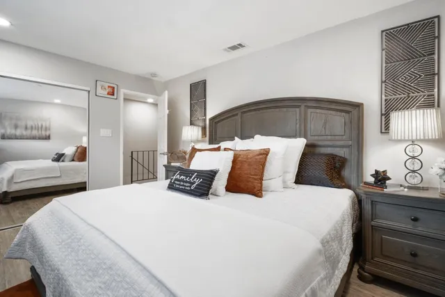 a bedroom with a bed and a mirror