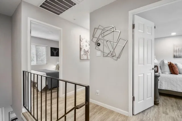a view of a hallway with a livingroom and entryway