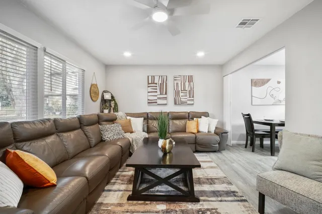 a living room with furniture a rug and a table