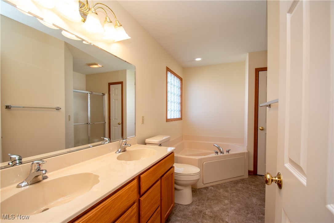 7007 Clingan Road, Unit 64 Youngstown, OH 44514 - Photo 20 of 50 Master bath offers double vanity, linen closet, high ceiling.