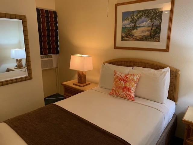 3411 Wilcox Road, Unit 110 Lihue, HI 96766 - Photo 12 of 12 a bedroom with a bed and wall painting