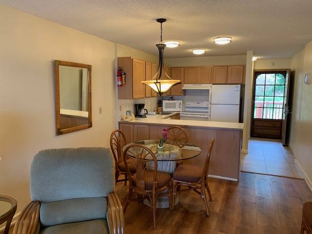 3411 Wilcox Road, Unit 110 Lihue, HI 96766 - Photo 4 of 12 a view of a dining room with furniture and wooden floor