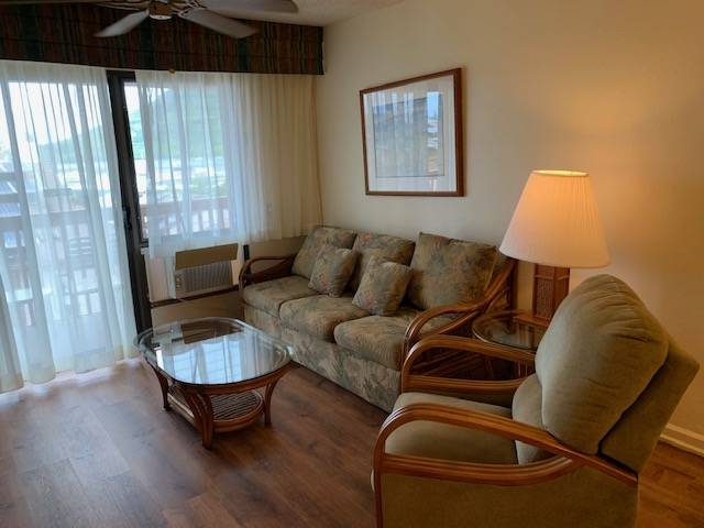 3411 Wilcox Road, Unit 110 Lihue, HI 96766 - Photo 6 of 12 a living room with furniture and a window