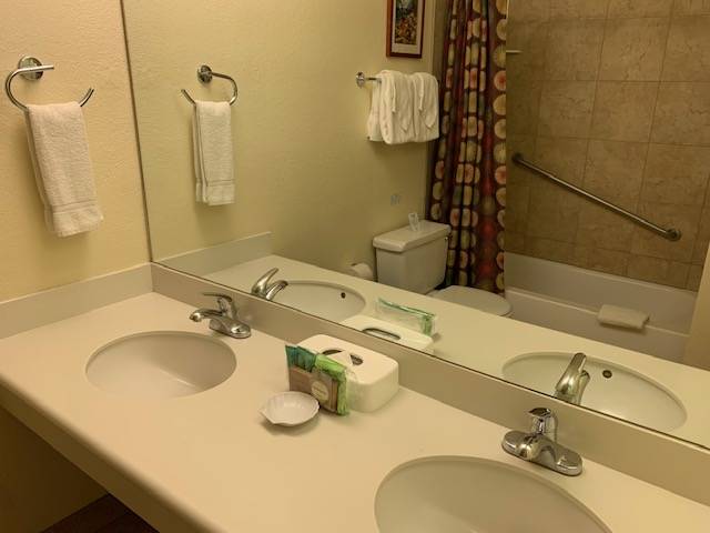 3411 Wilcox Road, Unit 110 Lihue, HI 96766 - Photo 7 of 12 a bathroom with a sink and a mirror