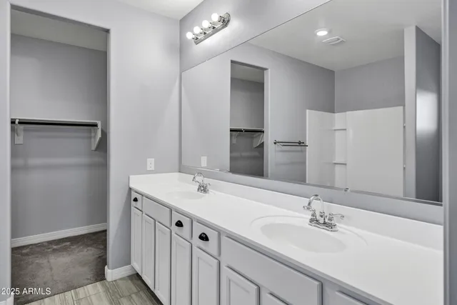 a bathroom with a sink double vanity and a mirror