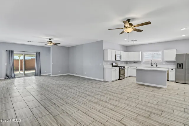 a view of a kitchen with microwave and cabinets