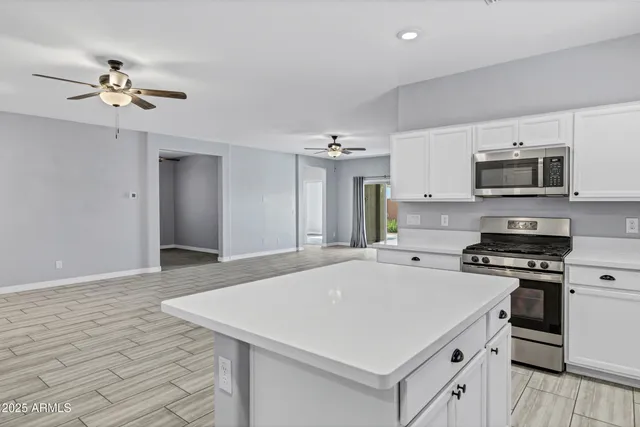 a kitchen with a stove a sink and a refrigerator