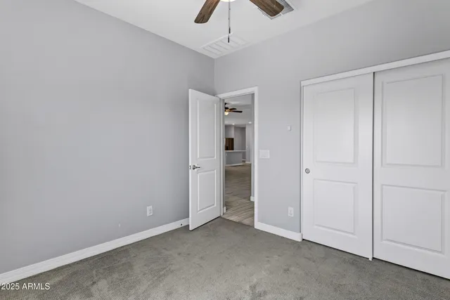 a view of an empty room and closet area