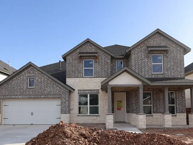 a front view of a house with a garage