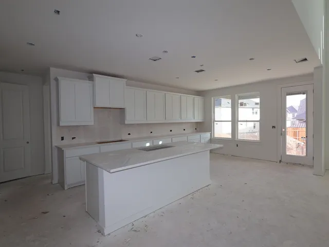 a view of a kitchen with a sink dishwasher and a refrigerator
