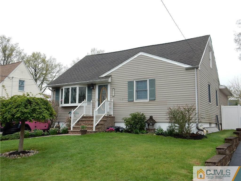61 Kimberly Road Colonia, NJ 07067 - Photo 2 of 25 a white house that has a small yard and large trees